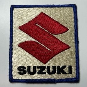 SUZUKI 2 15/16”x3 7/16” Red S Logo Patch w/ Black Suzuki, Blue Border, Tan Back